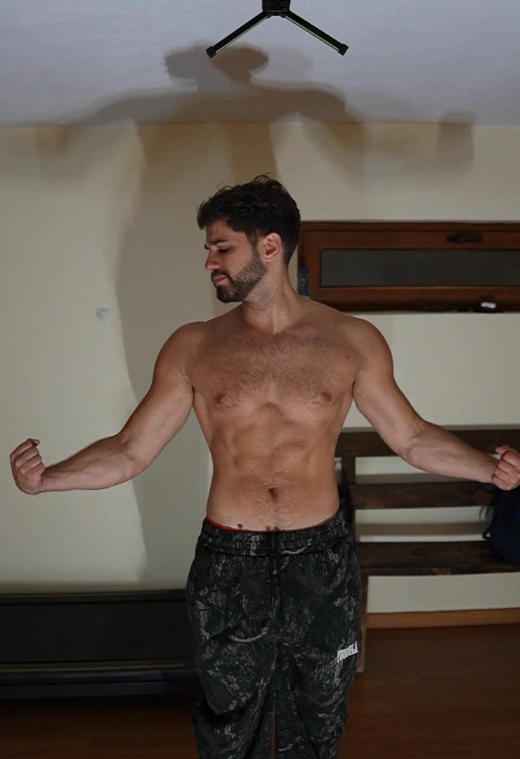 Physique photo shot under flat overhead gym lighting, definition washed out